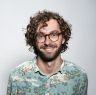 smiling man with glasses and beard portrait